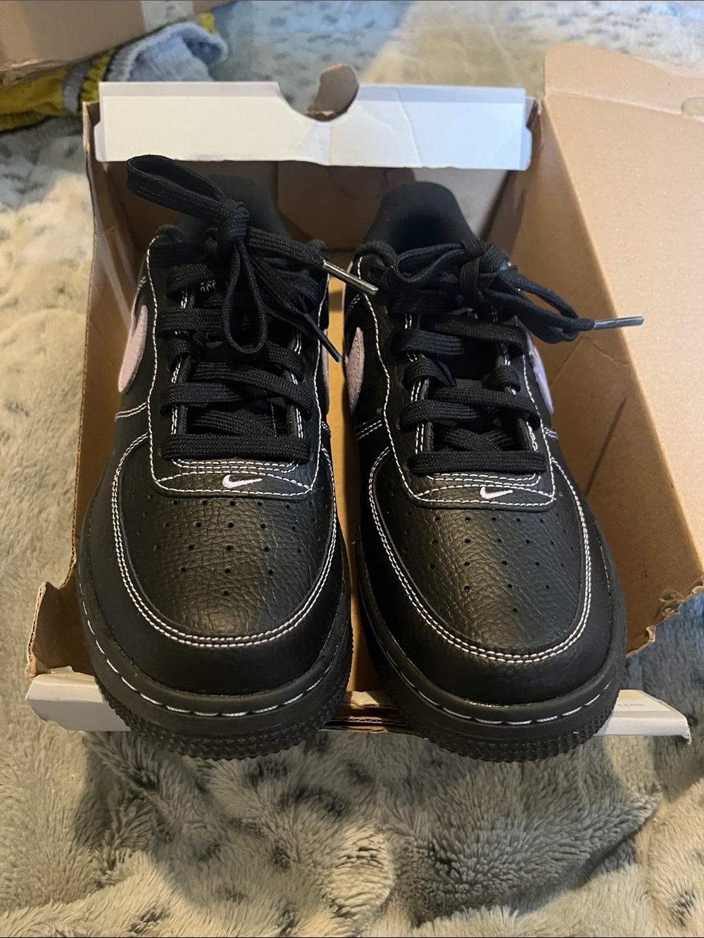 Nike Kids Black Sneakers with Purple Swoosh Accent